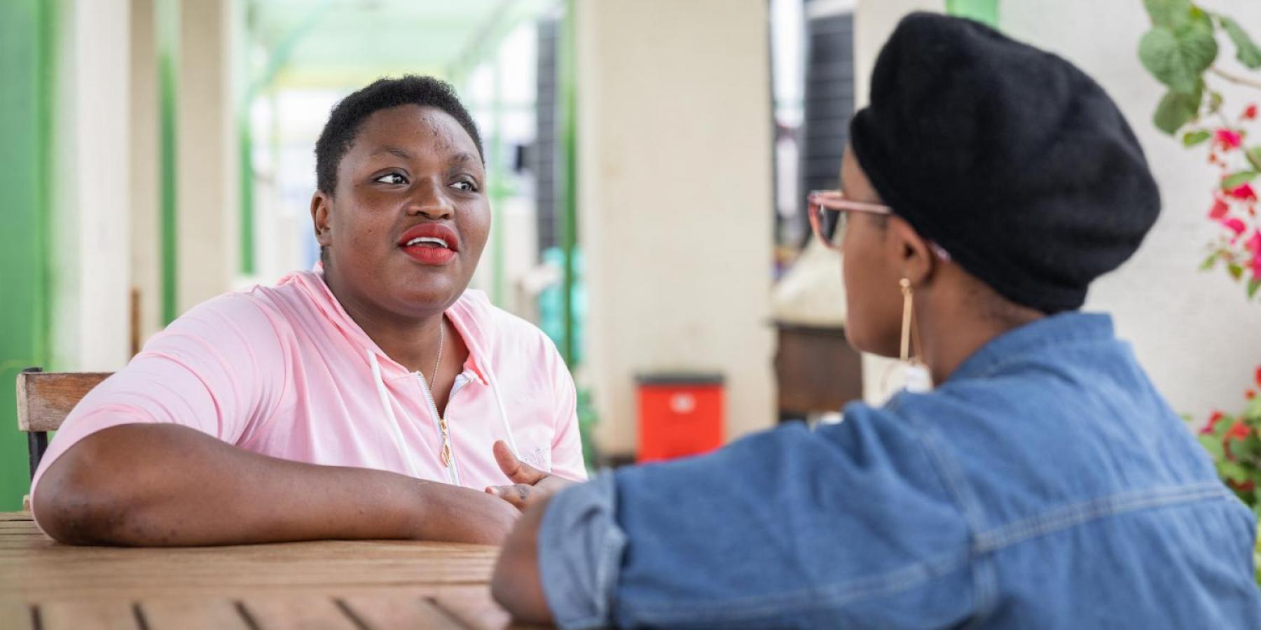 A person living with HIV talks to a friend in Nairobi