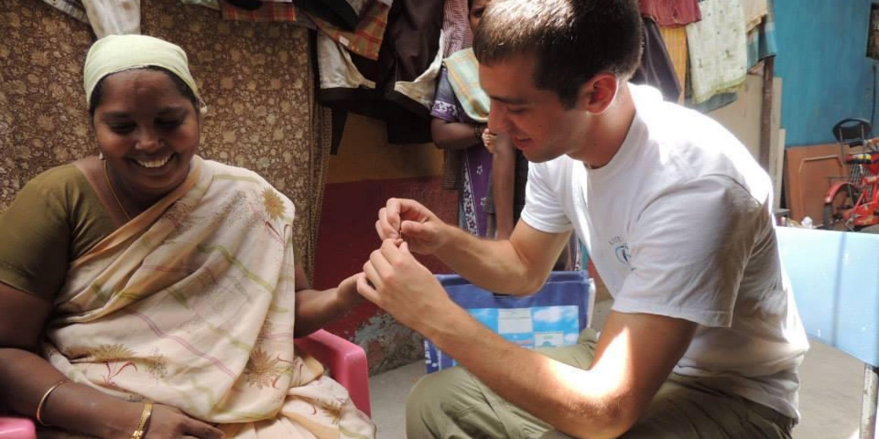 A medical student takes blood glucose levels at a mobile cataract clinic in Chennai, India 