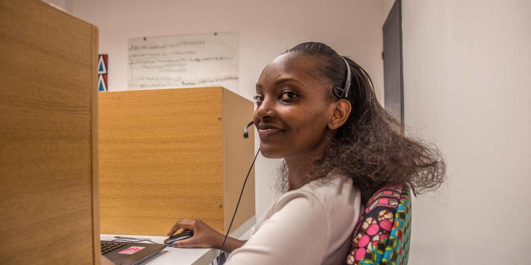 Woman working at computer smiling