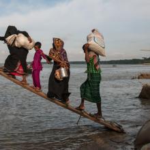  Climate-affected internally displaced persons board a boat to travel to Dhaka, Bangladesh. 