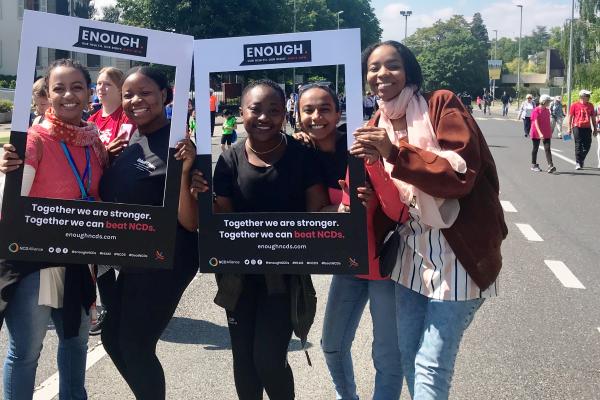 A group of women Walking the Talk, with Enough campaign photo frames, on the streets of Geneva